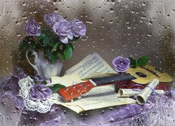 Gitara z nutami koło kwiatów w wazonie