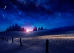 Gwiaździsta noc nad zasypanym śniegiem wzgórzem