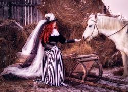 Kobieta w kapeluszu i biały koń