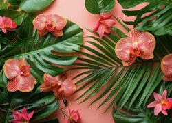 Nakrapiane kwiaty orchidei na liściach