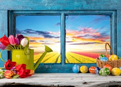 Okno wielkanocnie udekorowane kolorowymi pisankami i tulipanami