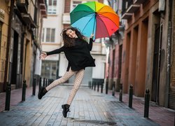 Radosna dziewczyna z kolorowym parasolem