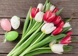 Trzy pisanki i bukiet tulipanów na deskach