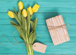 Żółte tulipany z prezentem i bilecikiem