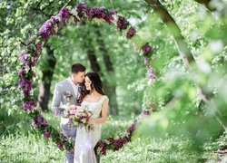 Nowożeńcy w okręgu z kwiatów bzu
