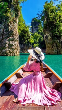 Kobieta w różowej sukience na łódce