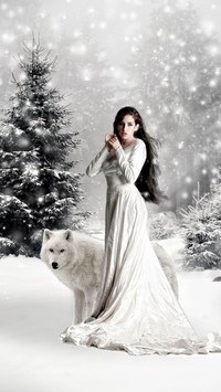 Kobieta z wilkiem w zimowym lesie