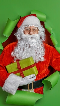 Mikołaj z prezentem na zielonym tle