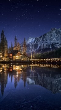 Oświetlony nocą dom nad jeziorem Emerald Lake