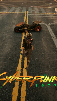 Postać i motocykl na ulicy z gry Cyberpunk 2077