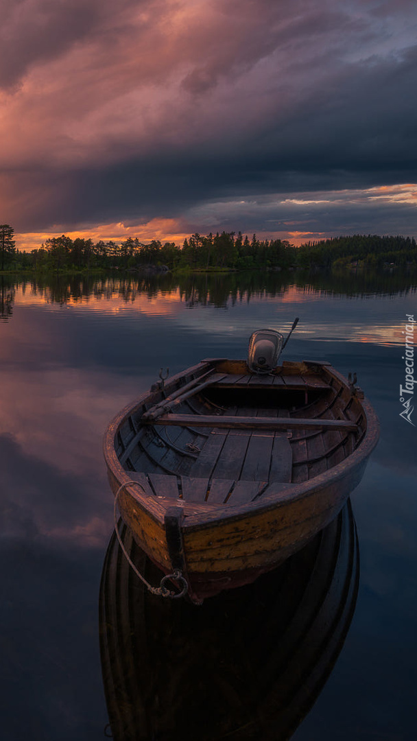 Łódka na jeziorze o zachodzie słońca