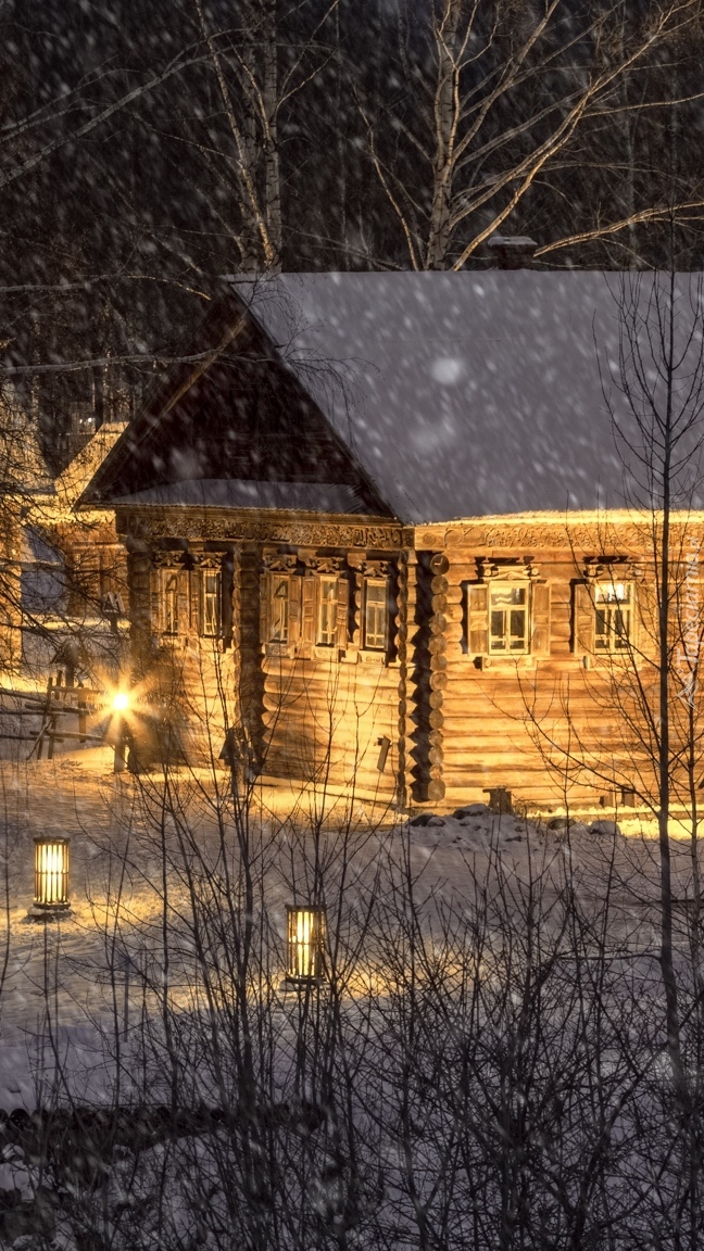 Oświetlone drewniane domy zimą