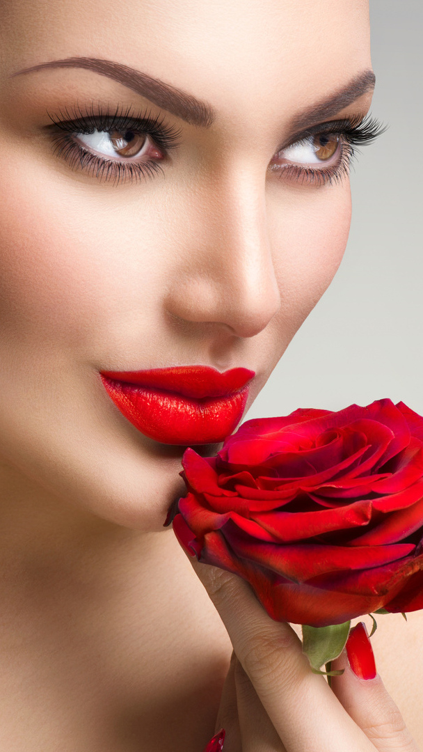 Uśmiechnięta kobieta z czerwoną różą
