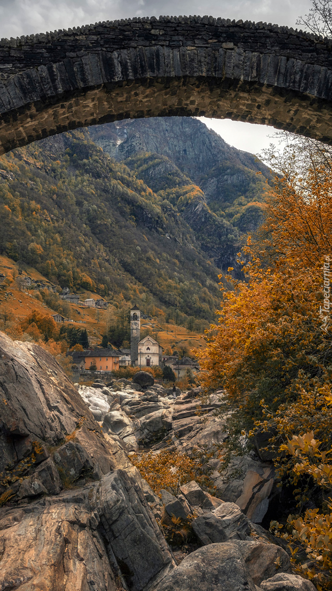 Widok zza mostu na zabudowania w górach