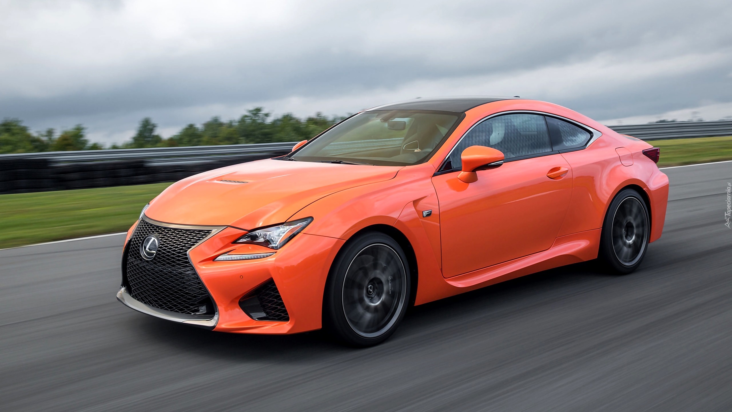 Pomarańczowy Lexus RC mknie asfaltową drogą