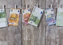 Banknoty euro przypięte spinaczami do sznurka