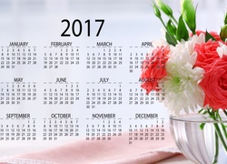 Biało-czerwony bukiet kwiatów w wazonie obok kalendarza na 2017 rok