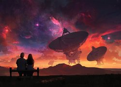 Chłopak z dziewczyną i radioteleskopy na tle nieba