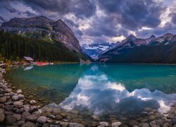 Ciemne chmury nad górami i jeziorem Louise w Kanadzie