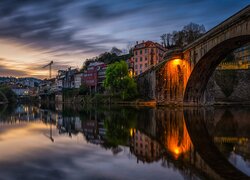 Domy i most Ponte Sao Goncalo nad rzeką Tamega w Amarante