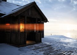Drewniana chata oświetlona lampą naftową