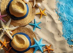 Dwa kapelusze i kolorowe rozgwiazdy na morskiej plaży