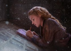 Dziewczyna pisząca w notatniku