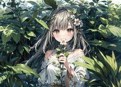 Dziewczyna z kwiatkiem w dłoni wśród liści