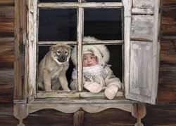 Dziewczynka i pies w oknie