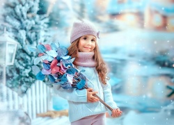 Dziewczynka z gałązkami na śniegu