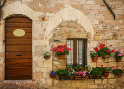 Fasada kamiennego budynku z kwiatami przy oknie