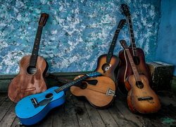 Gitary leżące na podłodze i oparte o ścianę