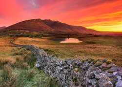 Jezioro Tewet Tarn w Parku Narodowym Lake District pod kolorowym niebem zachodzącego słońca