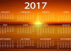 Kalendarz na 2017 rok z zachodzącym słońcem w tle