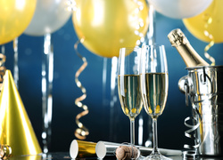 Kieliszki szampana, serpentyny i balony w sylwestrowej dekoracji
