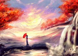 Kobieta z czerwoną parasolką podziwia wschód słońca