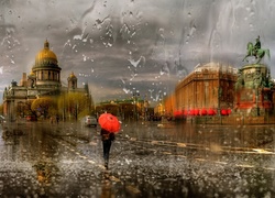 Kobieta z parasolką idzie w deszczu ulicą Petersburga