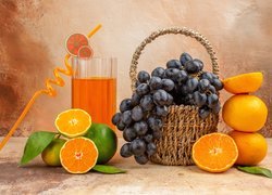 Koszyk winogron obok limonki i pomarańczy