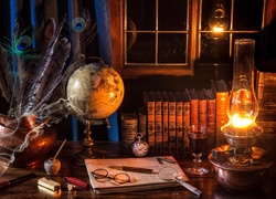 Lampa naftowa oświetla książki, globus i inne gadżety na stole