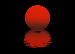 Łódka na tle zachodzącego słońca