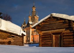 Ośnieżone drewniane domy i cerkiew