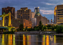 Oświetlone domy i most nad rzeką Missisipi w Minneapolis