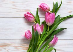 Różowe tulipany położone na deskach