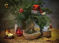 Świąteczna dekoracja z gałązkami, ozdobami i świeczką