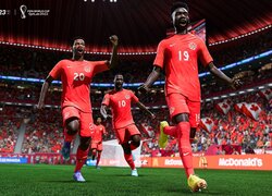 Szczęśliwi piłkarze w czerwonych strojach na boisku z gry FIFA 23