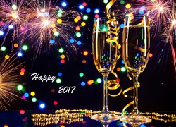 Życzenia noworoczne 2017 z kieliszkami szampana i fajerwerkami na niebie